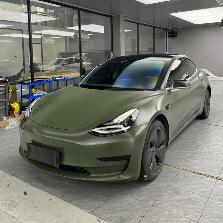 a green car parked in front of a building