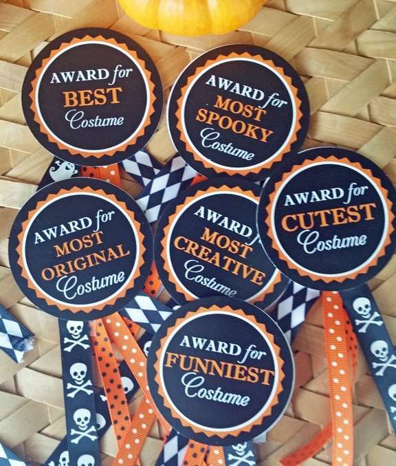 some badges that are sitting on top of a wicker basket next to a pumpkin