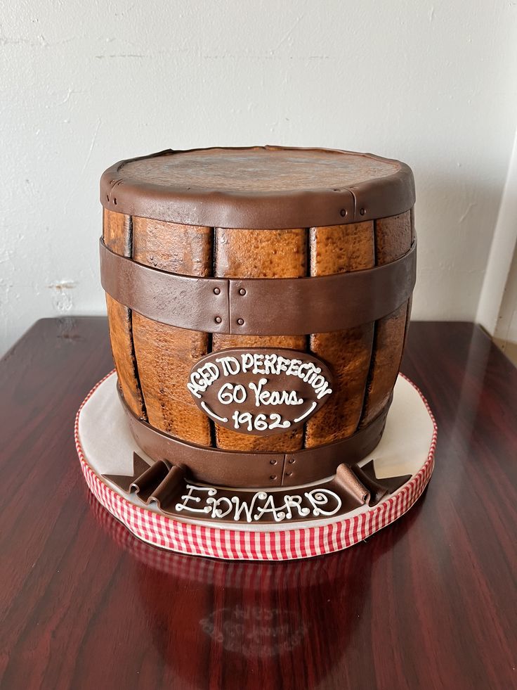 a cake made to look like a wooden barrel with writing on the top and bottom