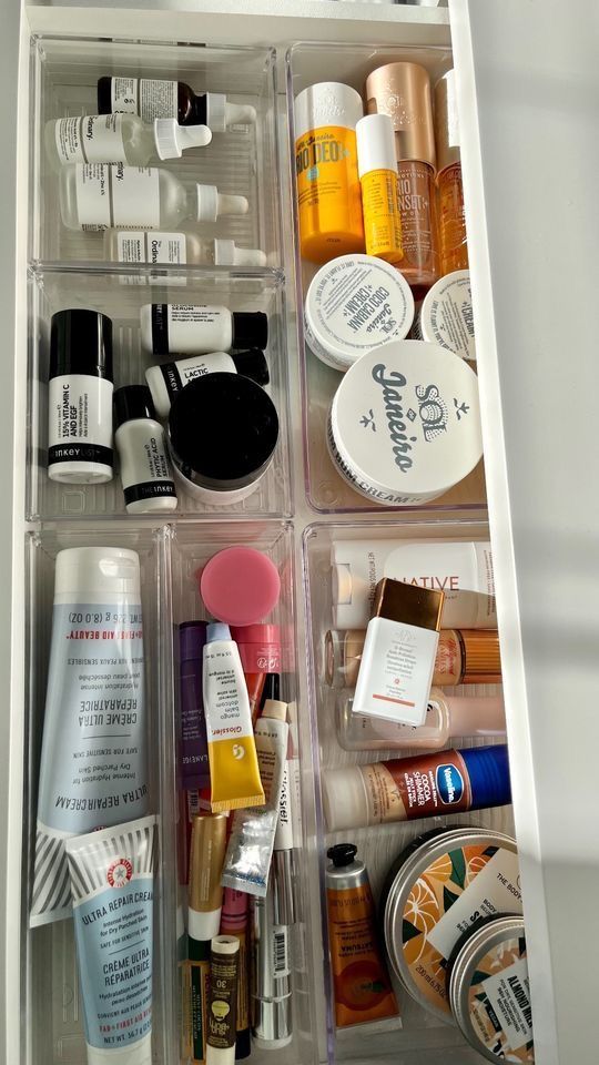 an organized drawer with various beauty products and makeup items in it's drawers,