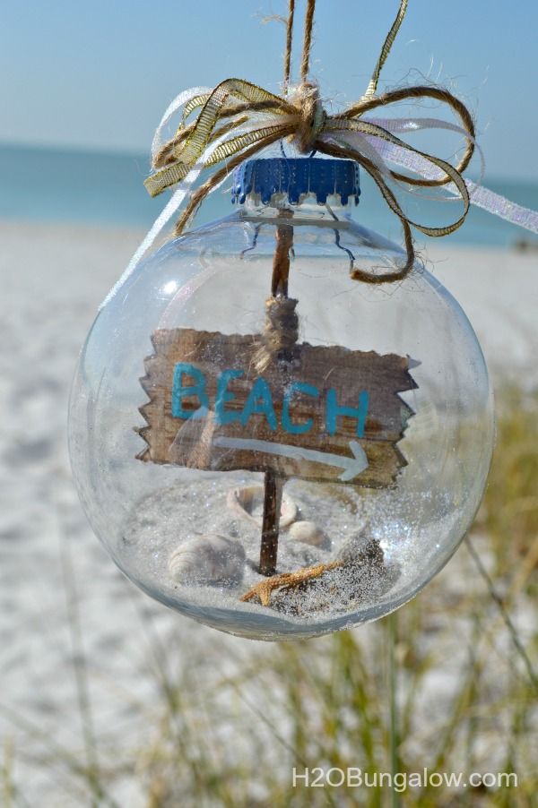 an ornament hanging from the side of a pole with a sign in it