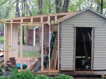 an outhouse is being built in the woods