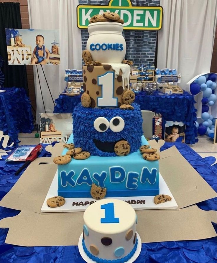 a birthday cake made to look like a cookie monster with cookies on it and the number 1