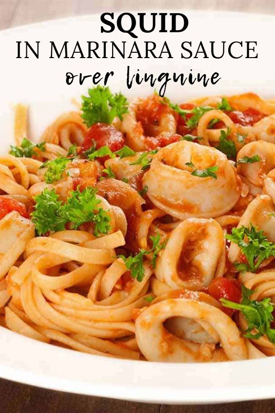 pasta with shrimp and tomato sauce in a white bowl