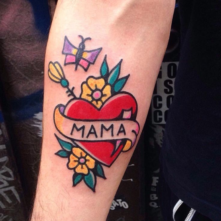 a tattoo on the arm of a man with flowers and a heart that says mama