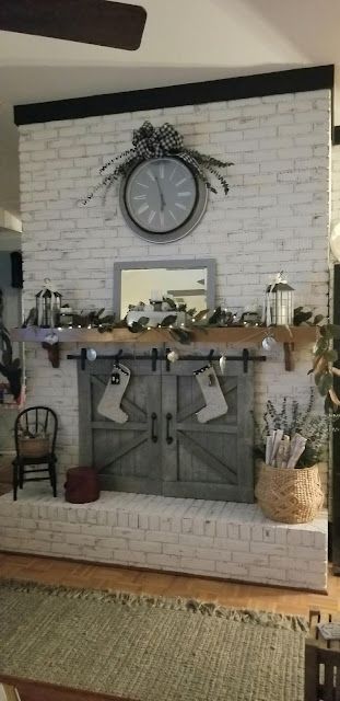 a living room filled with furniture and a clock on the wall over a fire place