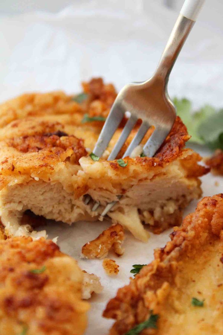 a fork is stuck into some food on a plate