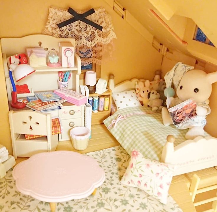 a doll house bedroom with teddy bears on the bed and other toys in the room