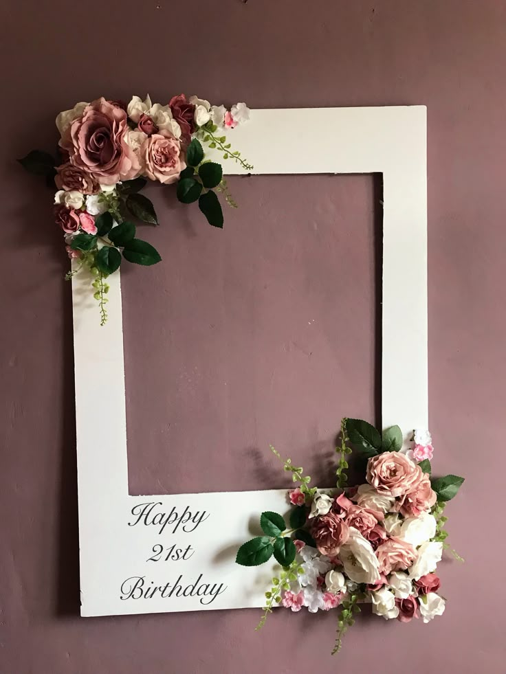 a white frame decorated with flowers and the words happy 1st birthday