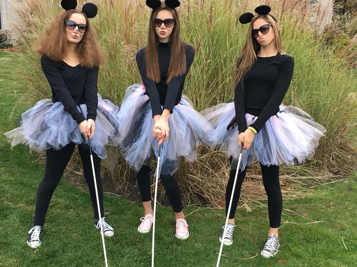 three girls dressed up as mickey mouses in tutu skirts and headbands