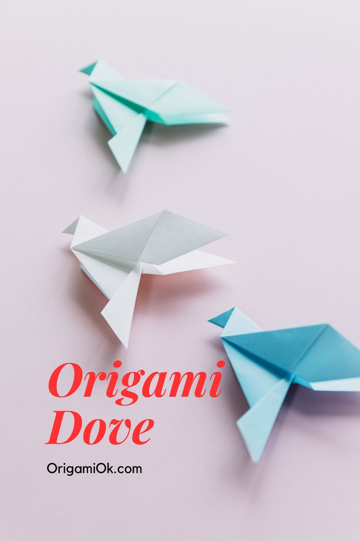 three origami doves sitting next to each other