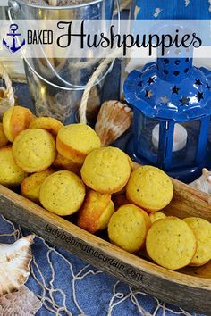 a boat filled with muffins sitting on top of a blue cloth covered table