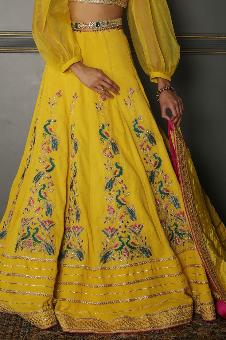 Mustard yellow pleated georgette lehenga with embroidered details. Comes with organza balloon sleeves blouse with hand crafted embroidery. Paired with Meenakari kundan , semi-precious jewelled kamarbandh and hand twisted silk crushed embroidered dupatta.
Components:4
Pattern:Embroidered
Type of Work:Resham and Gota
Neckline:Square
Sleeve Length:Puff Sleeves
Fabric:Lehenga: Pleated Georgette; Blouse: Silk; Sleeves: Organza; Dupatta: Pure Textured Silk
Color:Yellow
Other Details:
Cutwork hem neckl Aditi Gupta, Balloon Sleeves Blouse, Georgette Lehenga, Yellow Lehenga, Blouse Silk, Georgette Blouse, Embroidered Dupatta, Dupatta Set, Sleeves Blouse