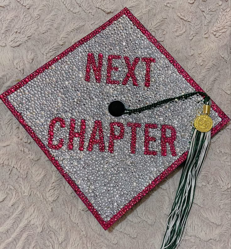 a graduation cap with the words next charter written in red and silver glitter on it