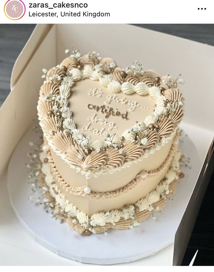 a heart shaped cake in a box with the words love written on it's side