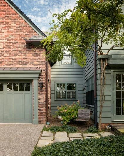 a brick house with two garages on the side