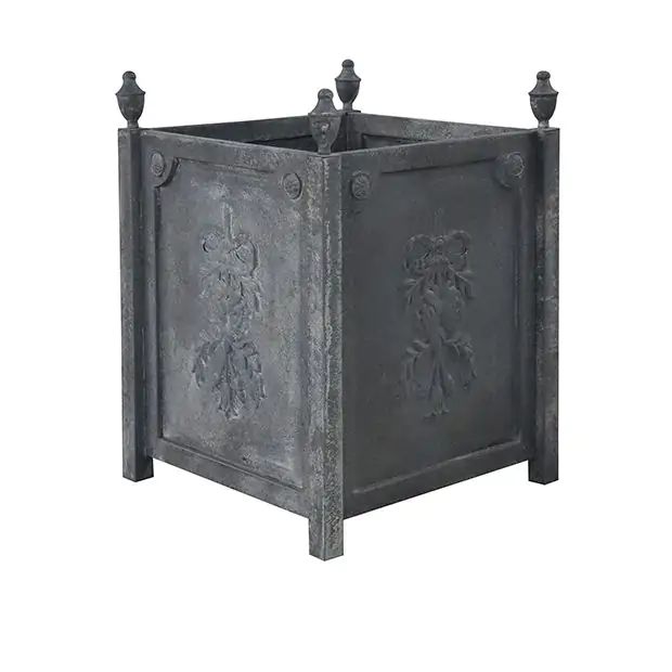 an old metal box with two statues on the front and back sides, sitting on a white background