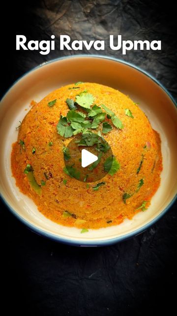 a white bowl filled with food on top of a black tablecloth and text that reads ragi ravia upma