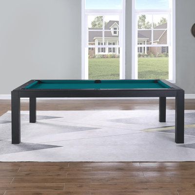 a pool table sitting on top of a hard wood floor next to a large window