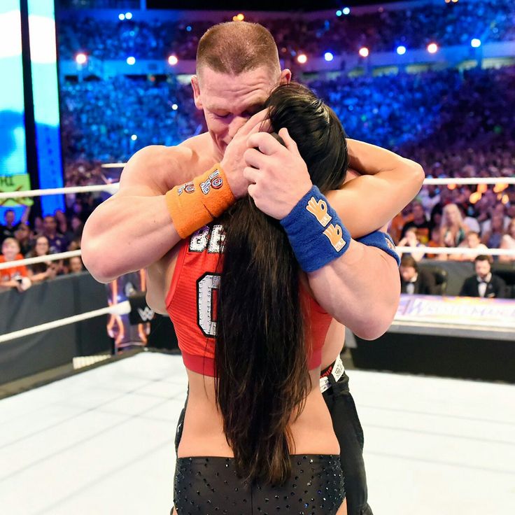 the wrestler is hugged by his partner