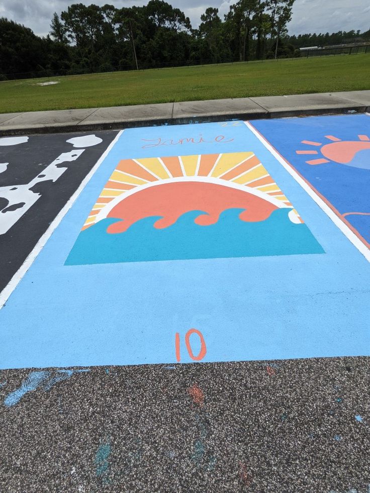 the parking lot has been painted with different colors and numbers for children to play in