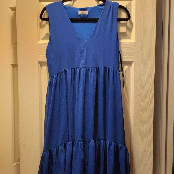 Blue Sleeveless Dress That Ties In The Back Size 8 Calvin Klein Sleeveless Summer Maxi Dress, Casual V-neck Calvin Klein Dress, Calvin Klein Casual V-neck Dress, Calvin Klein Sleeveless Maxi Dress For Spring, Calvin Klein Sleeveless Spring Maxi Dress, Calvin Klein Sleeveless Summer Midi Dress, Calvin Klein Summer V-neck Midi Dress, Blue Flowy Midi Sleeveless Dress, Blue Flowy Sleeveless Midi Dress