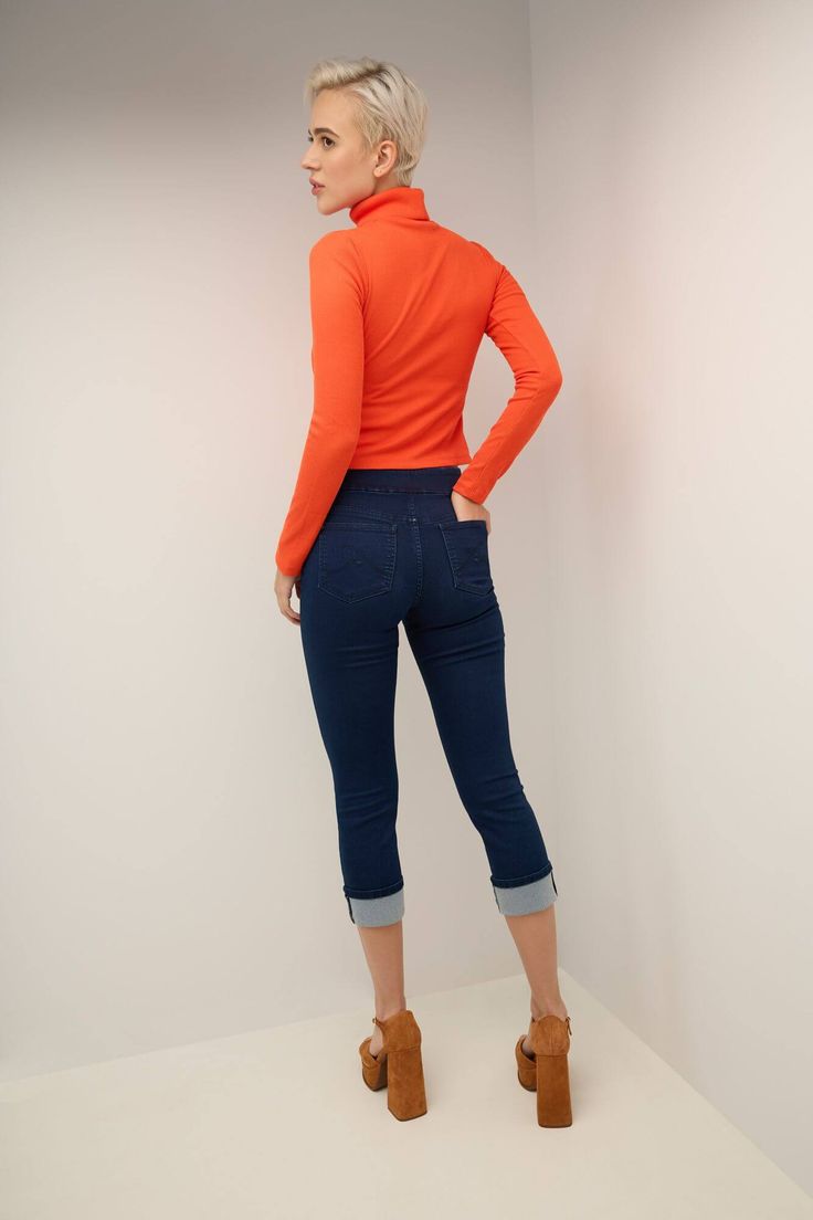 An everyday favorite, this skinny fit Capri jean offers the perfect blend of comfort and practicality thanks to its wide smoothing contour waistband that has a hidden elastic for easy pull-on styling with no need for buttons or zippers. The 25” inseam has been paired with a slim and fitted leg cut that slims down the body and makes it appear virtually airbrushed. Meanwhile, the mid-rise waistband lies just beneath the navel for all-day comfort. Metal rivets and a “R” logo to the back pockets. Th Casual Slim Fit Elastane Jeggings, Stretch Mid-rise Cropped Jeans For Fall, High Waist Stretch Cropped Jeans For Spring, Fall Slim Fit Cropped Leg Bottoms, Stretch Dark Wash Cropped Jeans, Stretch Cropped Leg Jeans In Dark Wash, Stretch Cropped Jeans In Dark Wash, Trendy Stretch Mid-rise Cropped Jeans, Fall Stretch Dark Wash Jeggings