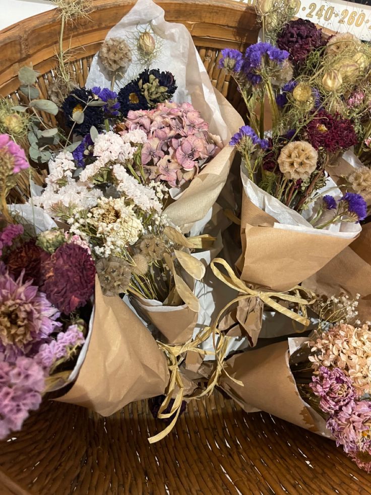 a basket filled with lots of different types of flowers