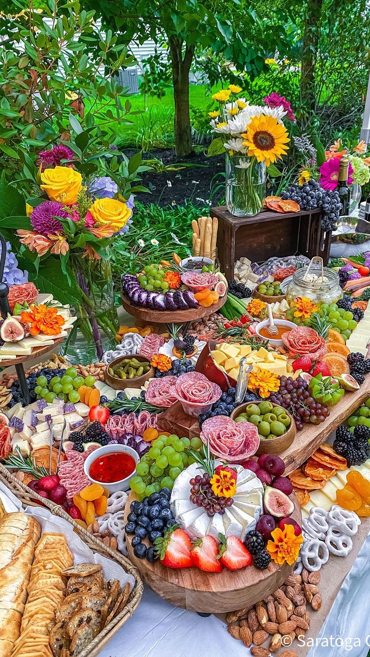 a table filled with lots of different types of food and desserts on top of it