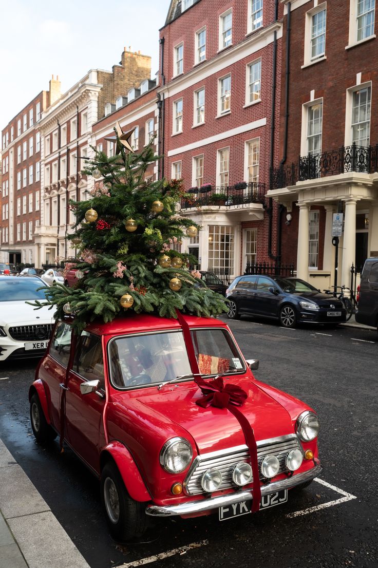 a small red car with a christmas tree on top