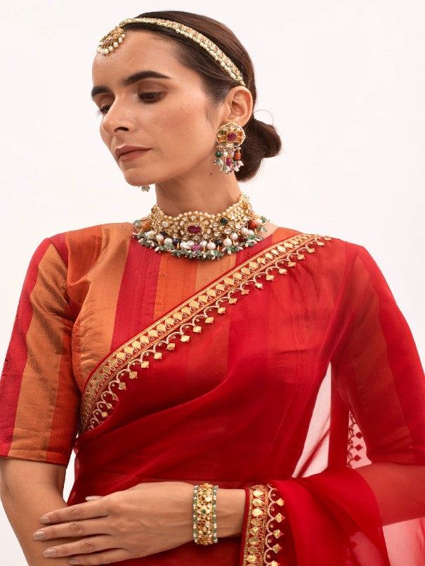 Featuring a Red saree in silk organza base with hand folded gota Patti Border. It is paired with matching Modal Satin Petticoat and Handloom Silk Stitched Blouse. Fabric: Pure Silk Organza,Pure Handloom Silk, Pure Modal Satin Lining Fabric - Cotton Color: Red Emboridery & Embellishments: Gota Patti Blouse Neck: Crew / Jewel neck Fit: Fitted at bust and waist Note: The product will be delivered within 3-4 weeks of the order placed The color and size can be customised Wash Care - Dry clean only Me Festive Organza Blouse Piece For Transitional Season, Festive Transitional Organza Blouse Piece, Traditional Pre-draped Saree With Unstitched Blouse In Organza, Silk Blouse Piece With Gota Work For Reception, Traditional Pre-draped Organza Saree With Unstitched Blouse, Traditional Organza Pre-draped Saree With Unstitched Blouse, Festival Blouse Piece With Sheer Dupatta For Reception, Traditional Wear Organza With Unstitched Blouse, Red Tissue Silk Traditional Wear With Dupatta