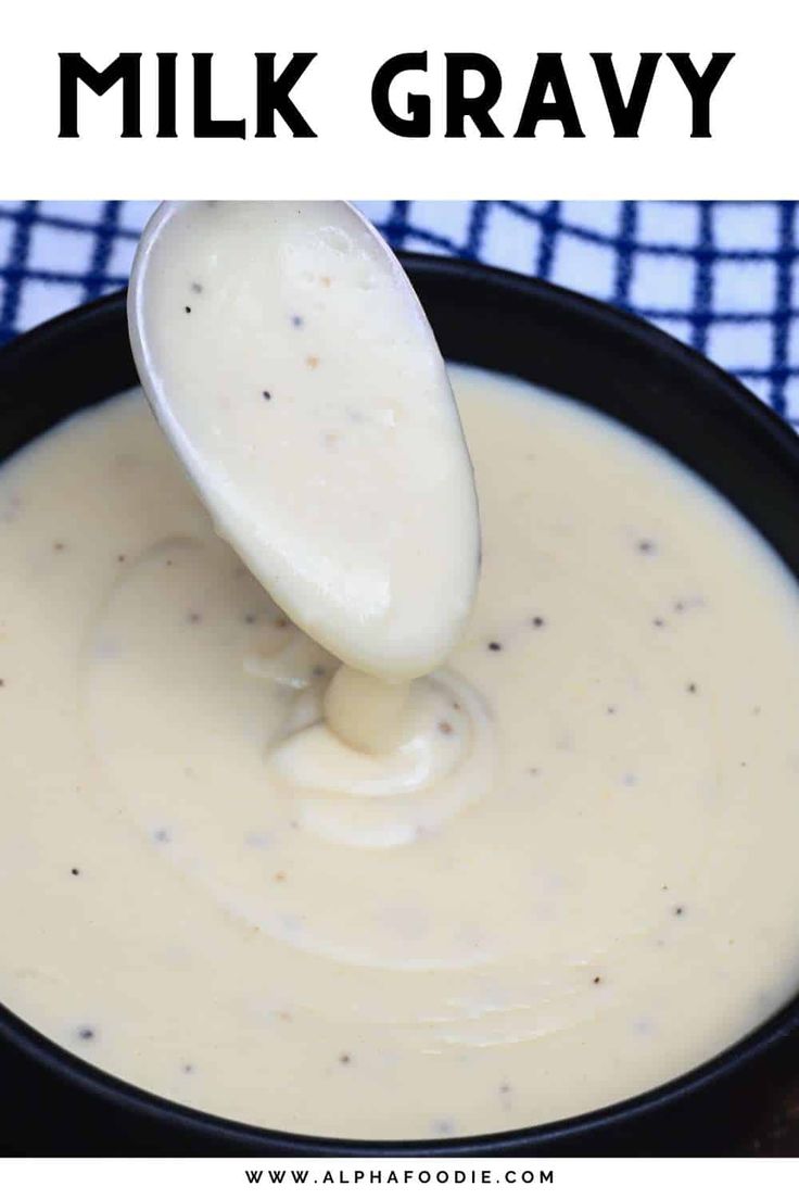 a spoon full of cream sauce with the words milk gravy above it in black and white