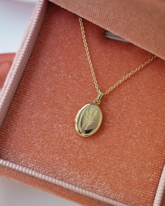 A lavender symbolizes purity, silence, devotion serenity, grace and calmness. Material: 14K Solid GoldHolds 2 photos19mm x 10mm (holds 2 photos)- The locket is about a nickel big, and a quarter in length total.Chain length: 18"- Other chain lengths available upon request. Additional charge may apply. Dainty Oval Pendant Locket Necklace For Anniversary, Gold Locket Necklace With Birthstone For Keepsake, 14k Gold Locket Necklace With Oval Pendant For Anniversary, Dainty 14k Gold Locket Necklace Gift, Gold Jewelry With Birth Flower For Memorial, Gold Birth Flower Jewelry For Memorial, Memorial Gold Jewelry With Birth Flower, Dainty Oval Pendant Locket Necklace For Gifts, Dainty 14k Gold Locket Necklace For Anniversary