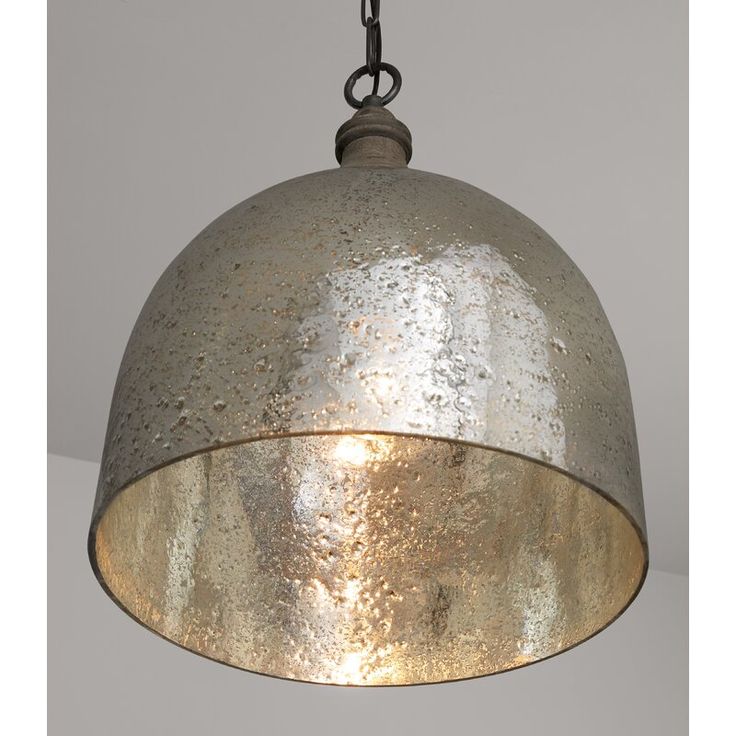 a metal light hanging from a chain