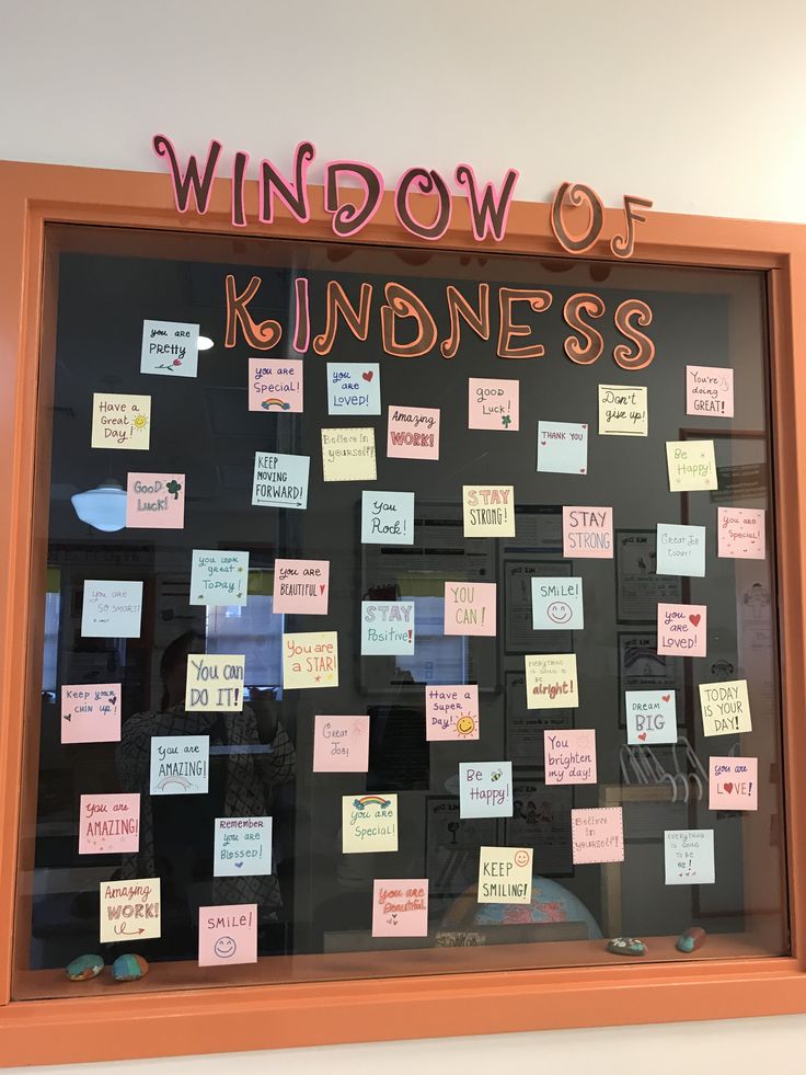 a bulletin board with sticky notes attached to the front and back of it in an orange frame