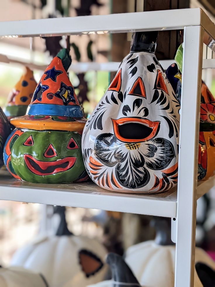 colorful ceramic pumpkins on shelves in a store