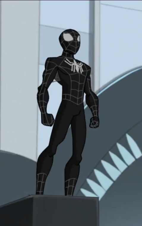 a black and white spider man standing on top of a pedestal in front of a building