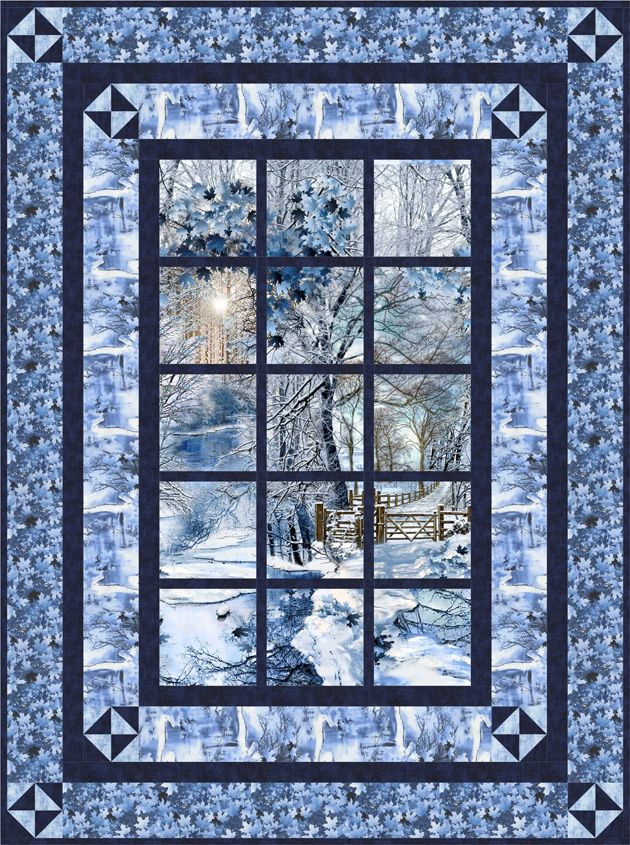 a quilted wall hanging with blue and white designs on the front, along with an image of snow covered trees