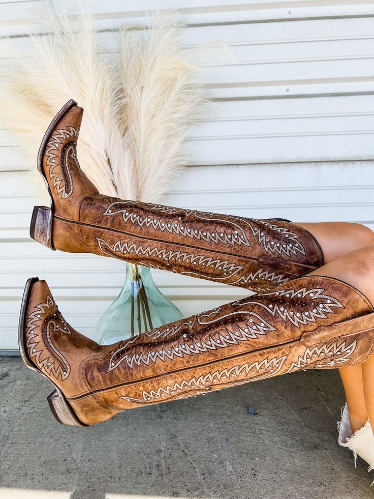 These cowboy boots are a must have in your closet. They are a literal staple piece. These knee high boots feature rhinestones throughout the boot. They are genuine leather handmade in Mexico. We recommend ordering your normal boot size as these do run true to size. Our model is 5'4 wearing a 9, her normal shoe size. Womens Western Shoes, Diy Cowboy Boots, Western Boots Wedding, Knee High Cowboy Boots Outfit, Cowgirl Boots And Jeans, Over The Knee Cowboy Boots, Boot Shelf, Knee High Cowgirl Boots, Boot Wall