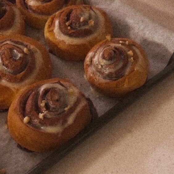 several cinnamon rolls sitting on top of a baking sheet