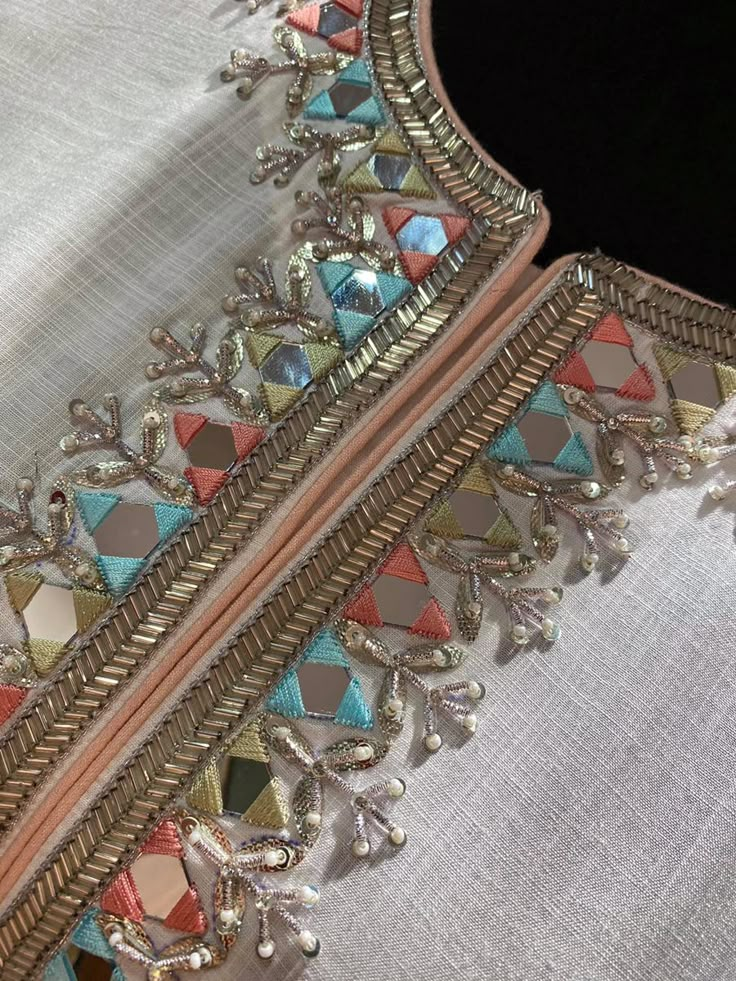 a close up of a piece of cloth with beading and beads on the edge