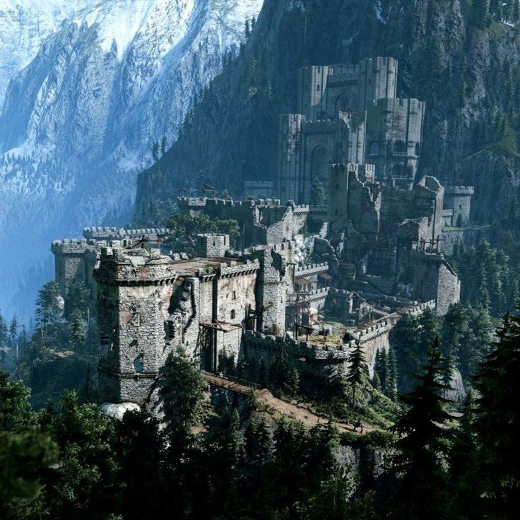 an old castle perched on top of a mountain surrounded by trees and snow covered mountains