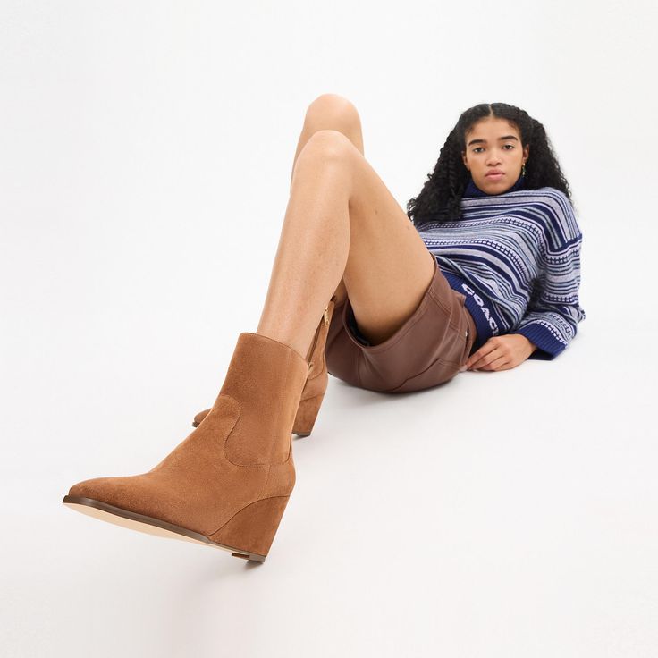 The Josephine Bootie is crafted of soft suede featuring a leather lining and footbed for all-day comfort and a rubber outsole for durability. Its sleek silhouette can be dressed up and down for any occasion. These suede wedge booties also offer a subtle lift without compromising on ease of wear. Fall Wedge Boots With Leather Sole And Round Toe, Casual Suede Heeled Boots For Winter, Fall Wedge Ankle Boots With Leather Sole, Fall Suede Mid-calf Boots Medium Width, Casual Suede Mid-calf Boots For Work, Casual Mid-calf Boots With Leather Sole For Fall, Leather Wedge Heel Boots For Winter, Ankle-high Wedge Boots For Workwear In Fall, Winter Ankle Wedge Boots For Workwear