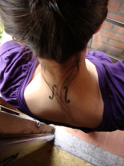 a woman with a small tattoo on her neck