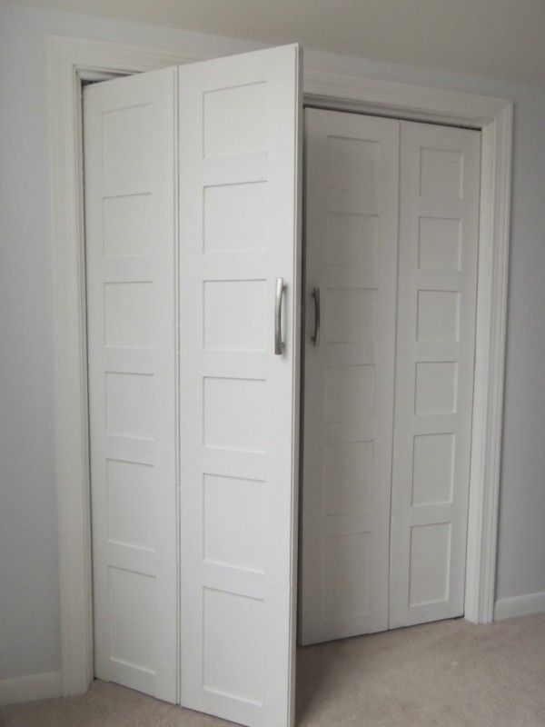 an empty room with two white doors open