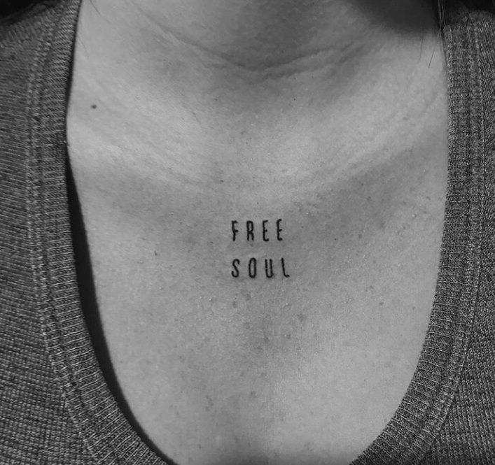 a woman's chest with the word free soul written on it in black ink