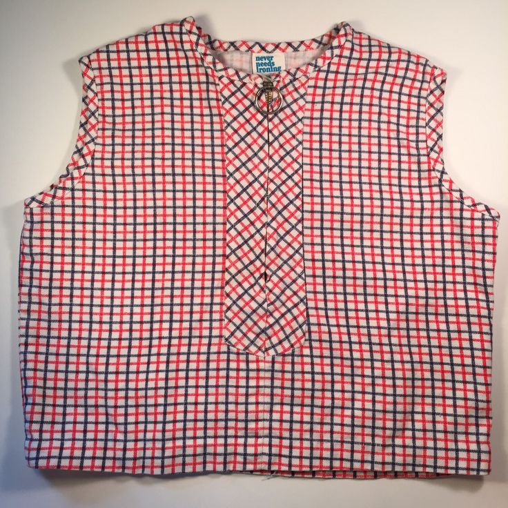 This is a fabulous vintage sleeveless blouse dating to the early 1960's. The shirt would look amazing with some pedal pushers or high waisted denim shorts for the summer. The blouse is red white and blue plaid with a silver zipper on the chest.  The shirt is in good condition for a garment of this age. It has light fading and a few small spots but is still very wearable. There are no size tags, so please check the measurements to ensure a proper fit. Chest- 30 inches Waist- 30 inches Length- 15 Retro Cotton Vest-style Top, Retro Sleeveless Cotton Tops, Retro Sleeveless Cotton Vest, Vintage Red Sleeveless Top, Vintage Vest Tops For Summer, Retro Sleeveless Vest Top, Casual Vintage Fashion Tops For Summer, Fitted Vintage Vest Top, Red Cotton Retro Vest