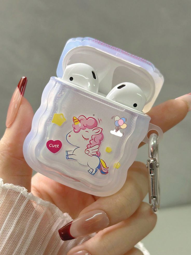 a woman holding an airpods case in her hand