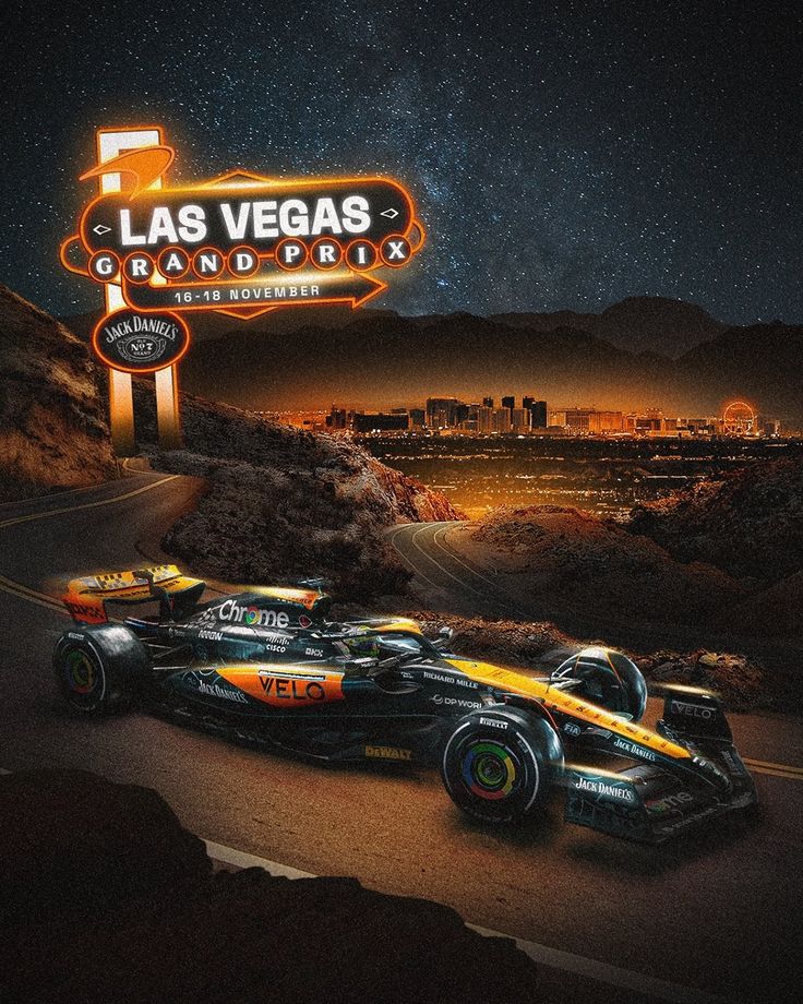 two racing cars on the road in front of las vegas grand prix sign at night