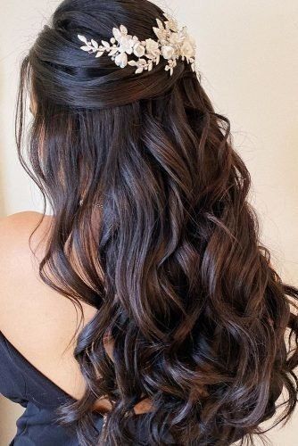 the back of a woman's head wearing a hair comb with flowers on it